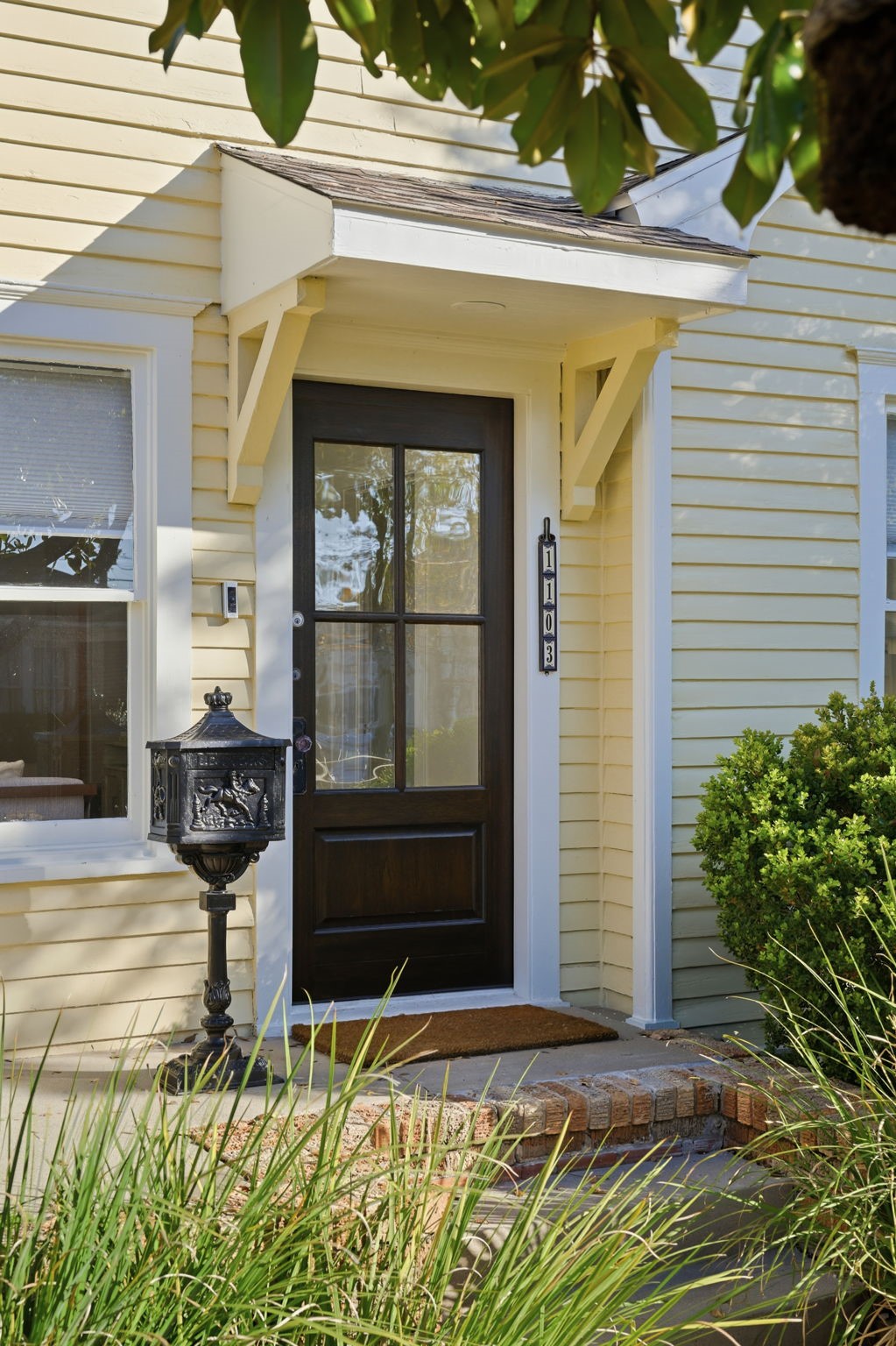 1103 Key Street Houston, TX 77009 - Photo 3 of 35 Charming front door with a small overhang. Features a vintage-style mailbox and well-maintained landscaping, creating a warm and welcoming appearance.