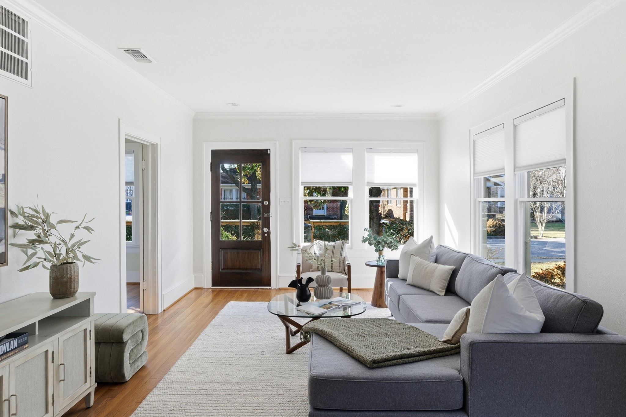 1103 Key Street Houston, TX 77009 - Photo 4 of 35 Bright and inviting living room featuring large windows, hardwood floors, and offering a warm and welcoming atmosphere.