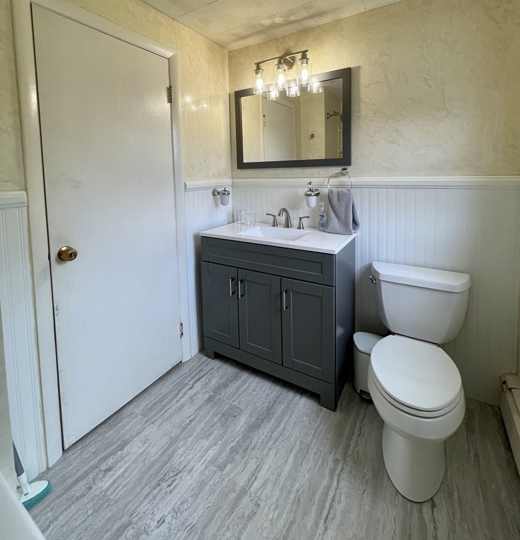 172 Potter Road Framingham, MA 01701 - Photo 13 of 16 a bathroom with a toilet sink vanity and mirror