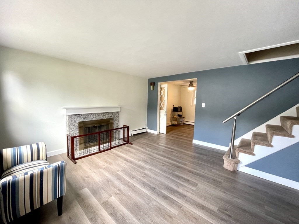 172 Potter Road Framingham, MA 01701 - Photo 3 of 16 a living room with furniture and a fireplace
