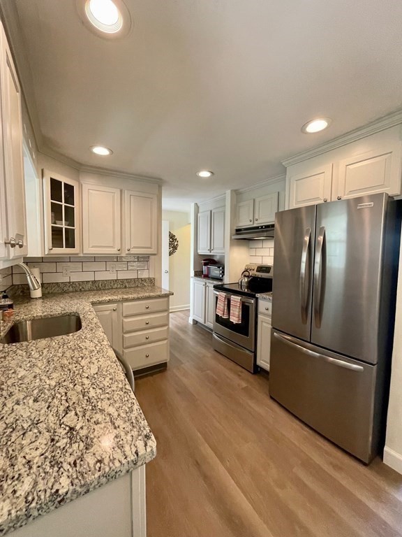 172 Potter Road Framingham, MA 01701 - Photo 4 of 16 a kitchen with stainless steel appliances granite countertop a refrigerator sink and stove