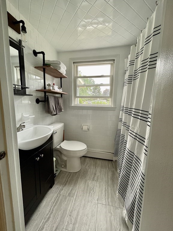 172 Potter Road Framingham, MA 01701 - Photo 7 of 16 a bathroom with a sink a toilet and mirror