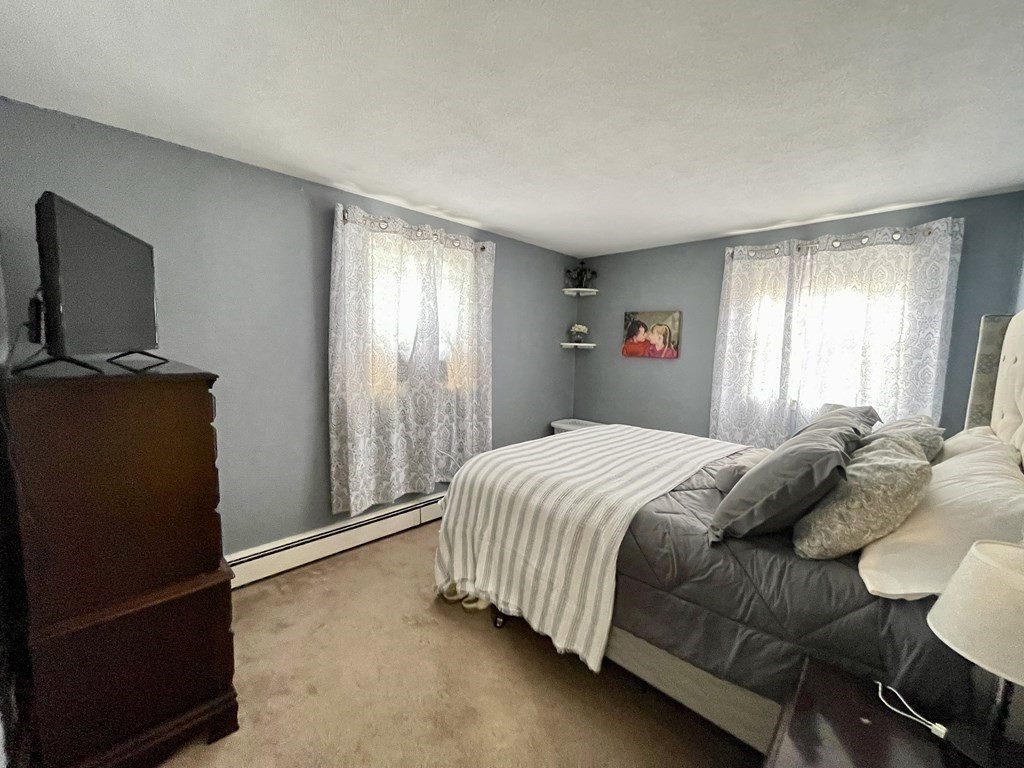 172 Potter Road Framingham, MA 01701 - Photo 10 of 16 a bedroom with a bed and flat screen tv