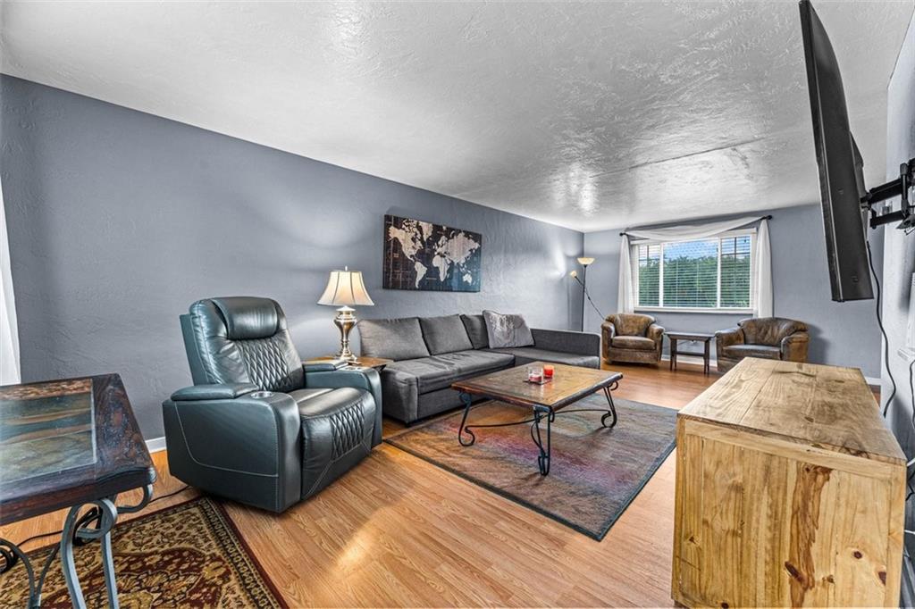 926 Agnew Road Pittsburgh, PA 15227 - Photo 3 of 22 a living room with furniture and a flat screen tv