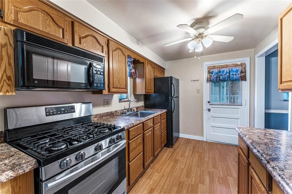 926 Agnew Road Pittsburgh, PA 15227 - Photo 7 of 22 a kitchen with a stove and a microwave