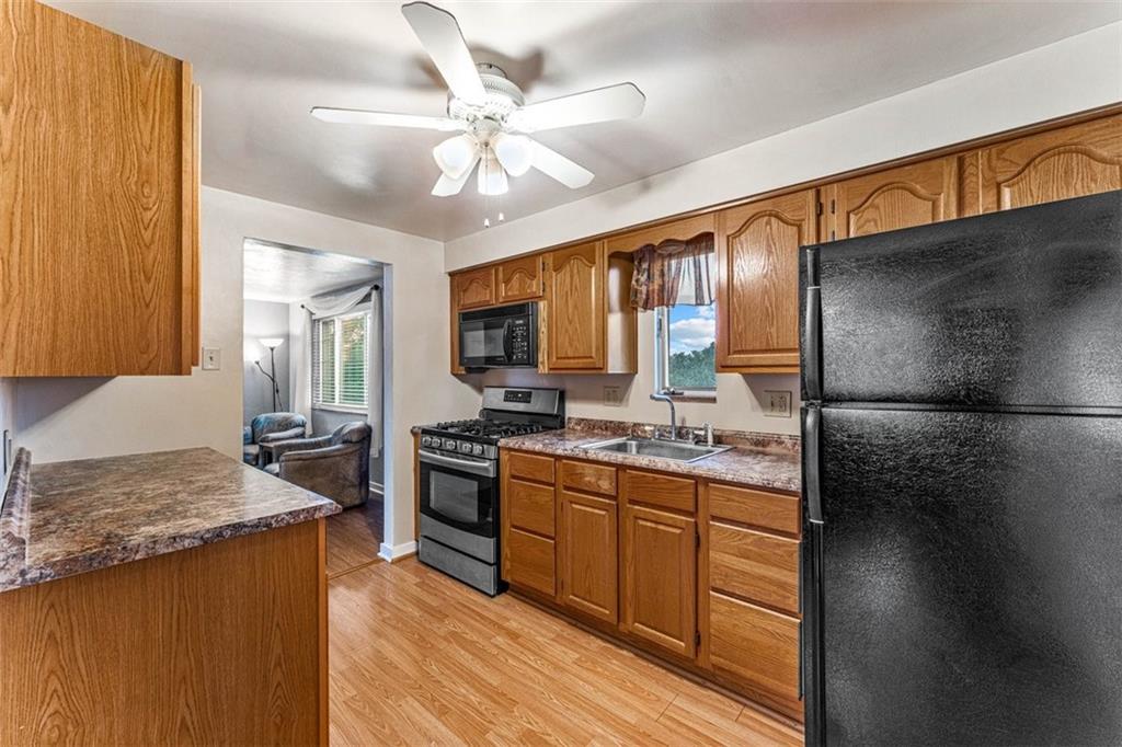 926 Agnew Road Pittsburgh, PA 15227 - Photo 8 of 22 a kitchen with stainless steel appliances granite countertop a sink stove and refrigerator