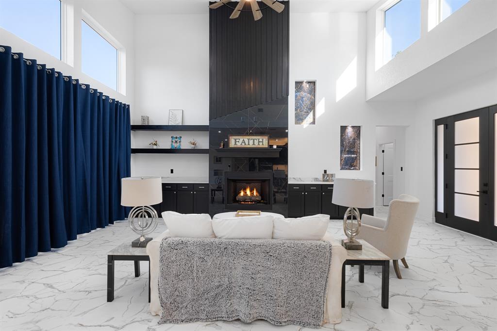 1572 Faulkner Road Sunset, TX 76270 - Photo 11 of 40 a living room with furniture a fireplace and kitchen view