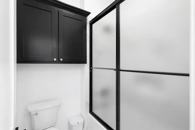 a bathroom with double vanity sinks and a mirror