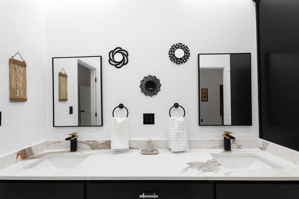 1572 Faulkner Road Sunset, TX 76270 - Photo 35 of 40 a bathroom with double vanity sinks and a mirror