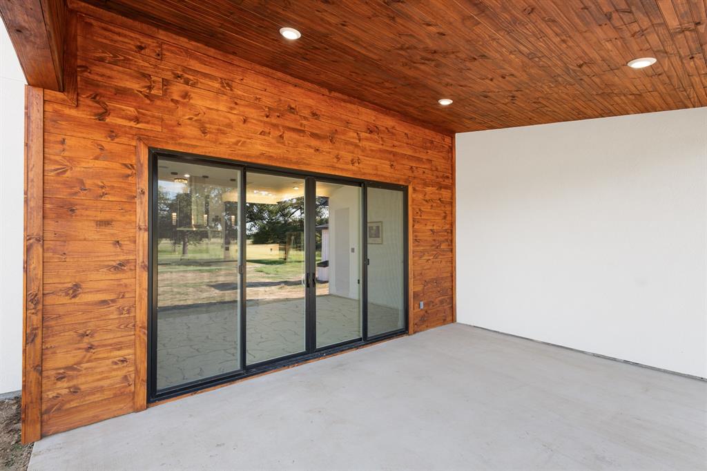 1572 Faulkner Road Sunset, TX 76270 - Photo 37 of 40 a view of an empty room with a sliding door