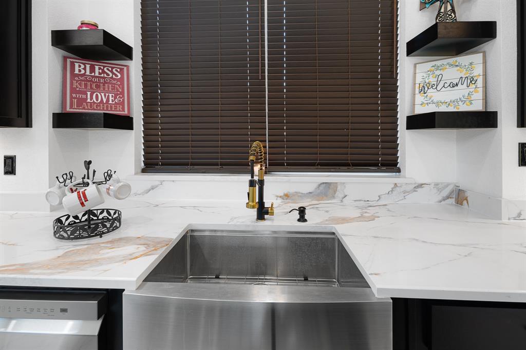 1572 Faulkner Road Sunset, TX 76270 - Photo 7 of 40 a kitchen with a sink and a stove