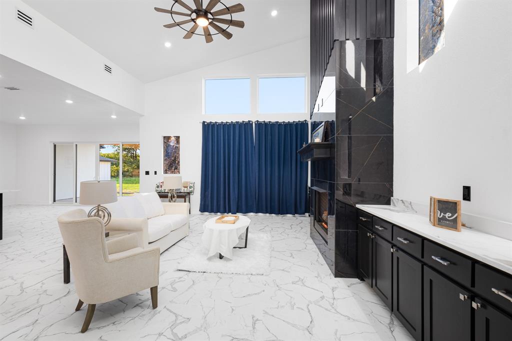 1572 Faulkner Road Sunset, TX 76270 - Photo 9 of 40 a large white kitchen with a large window and stainless steel appliances