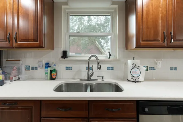 a kitchen with wooden cabinets and a stove top oven