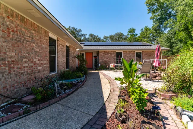 a view of a patio with table and chairs potted plants