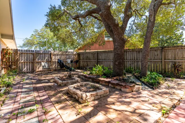 a large house with a big yard and large trees