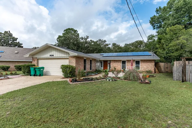 a view of a house with a yard and sitting area