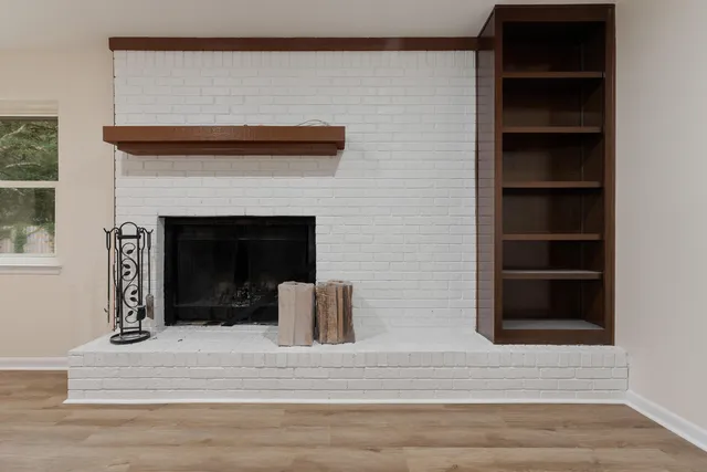 a bedroom with furniture and a mirror