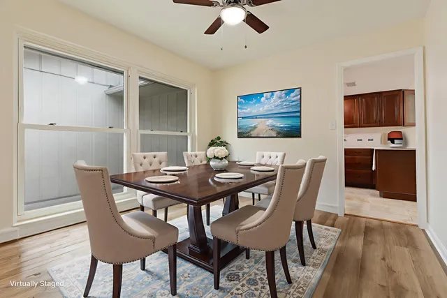 a spacious bedroom with a bed and a chandelier