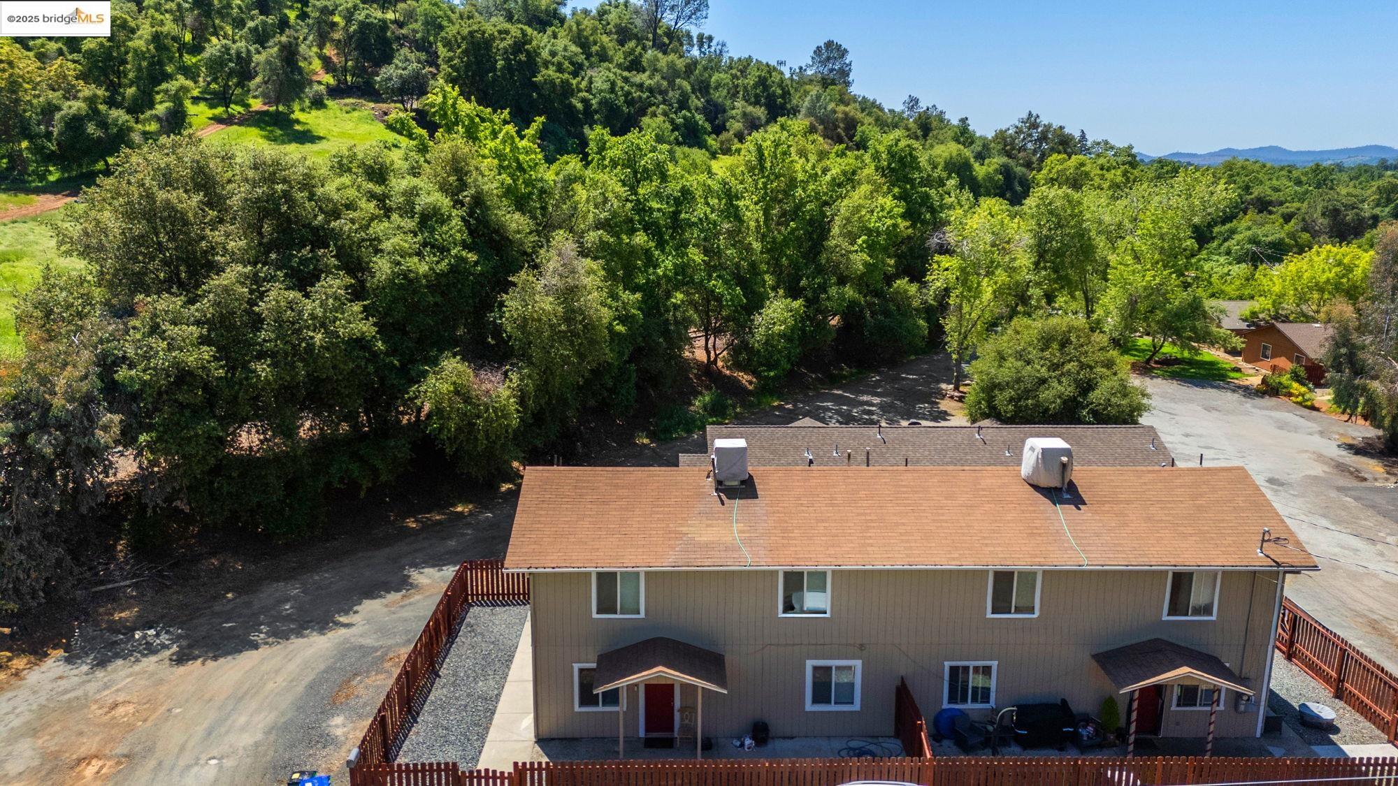 an aerial view of a house with yard