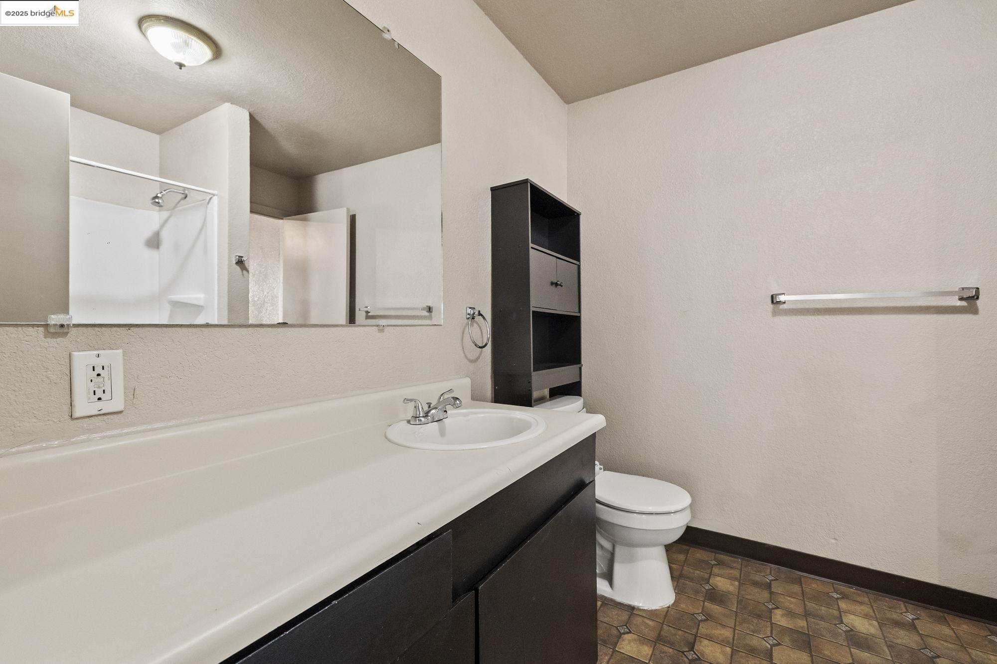 10702 10th Avenue Jamestown, CA 95327 - Photo 13 of 25 a bathroom with a sink a toilet and mirror