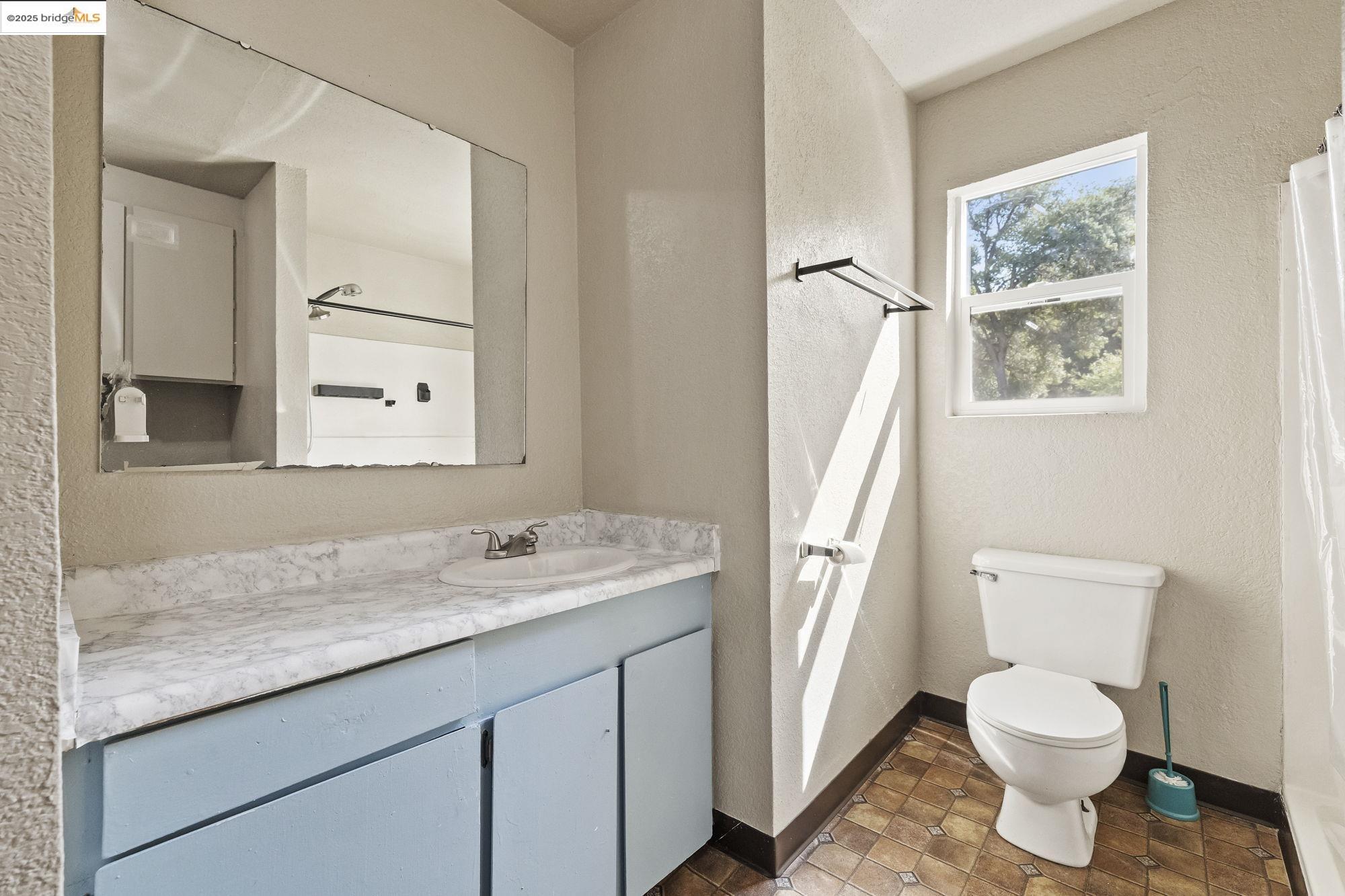 10702 10th Avenue Jamestown, CA 95327 - Photo 19 of 25 a bathroom with a granite countertop sink toilet and shower
