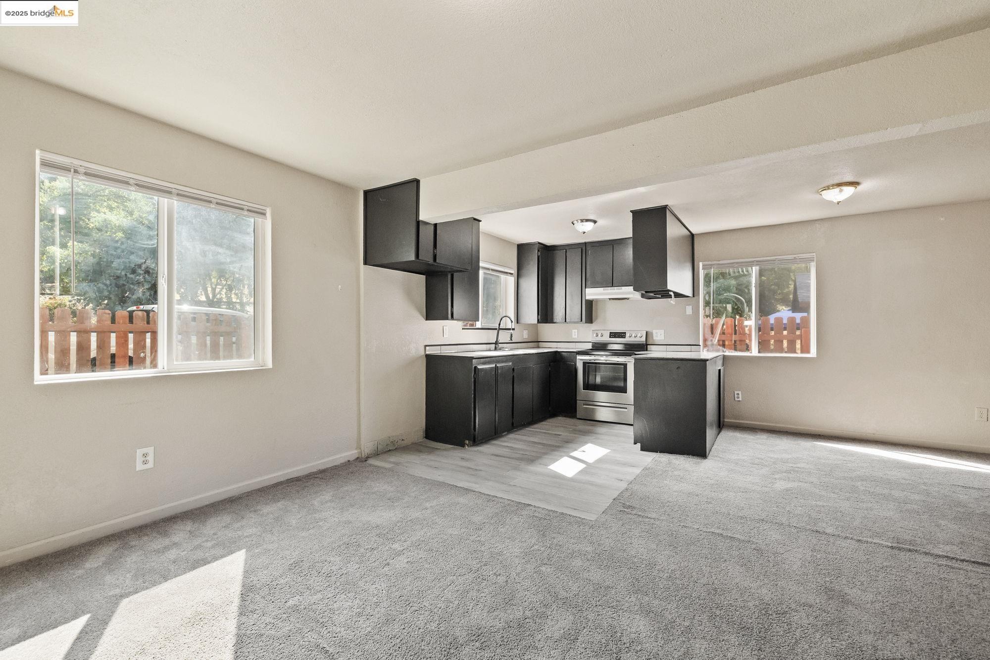 10702 10th Avenue Jamestown, CA 95327 - Photo 6 of 25 a kitchen with stainless steel appliances a refrigerator a sink a stove top oven a counter space and cabinets