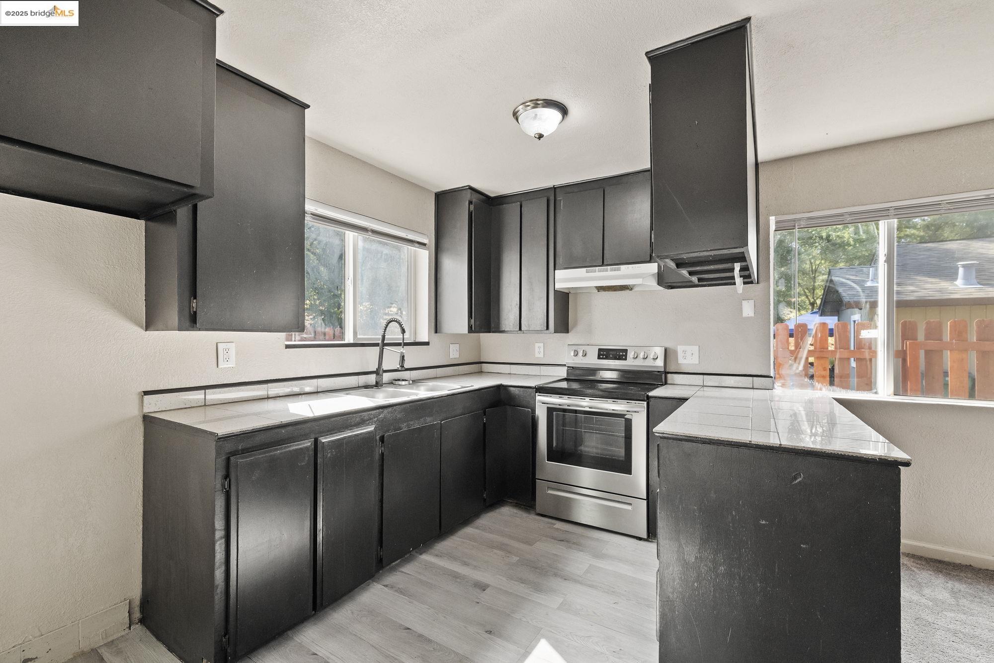 10702 10th Avenue Jamestown, CA 95327 - Photo 8 of 25 a kitchen with stainless steel appliances granite countertop a sink stove and refrigerator
