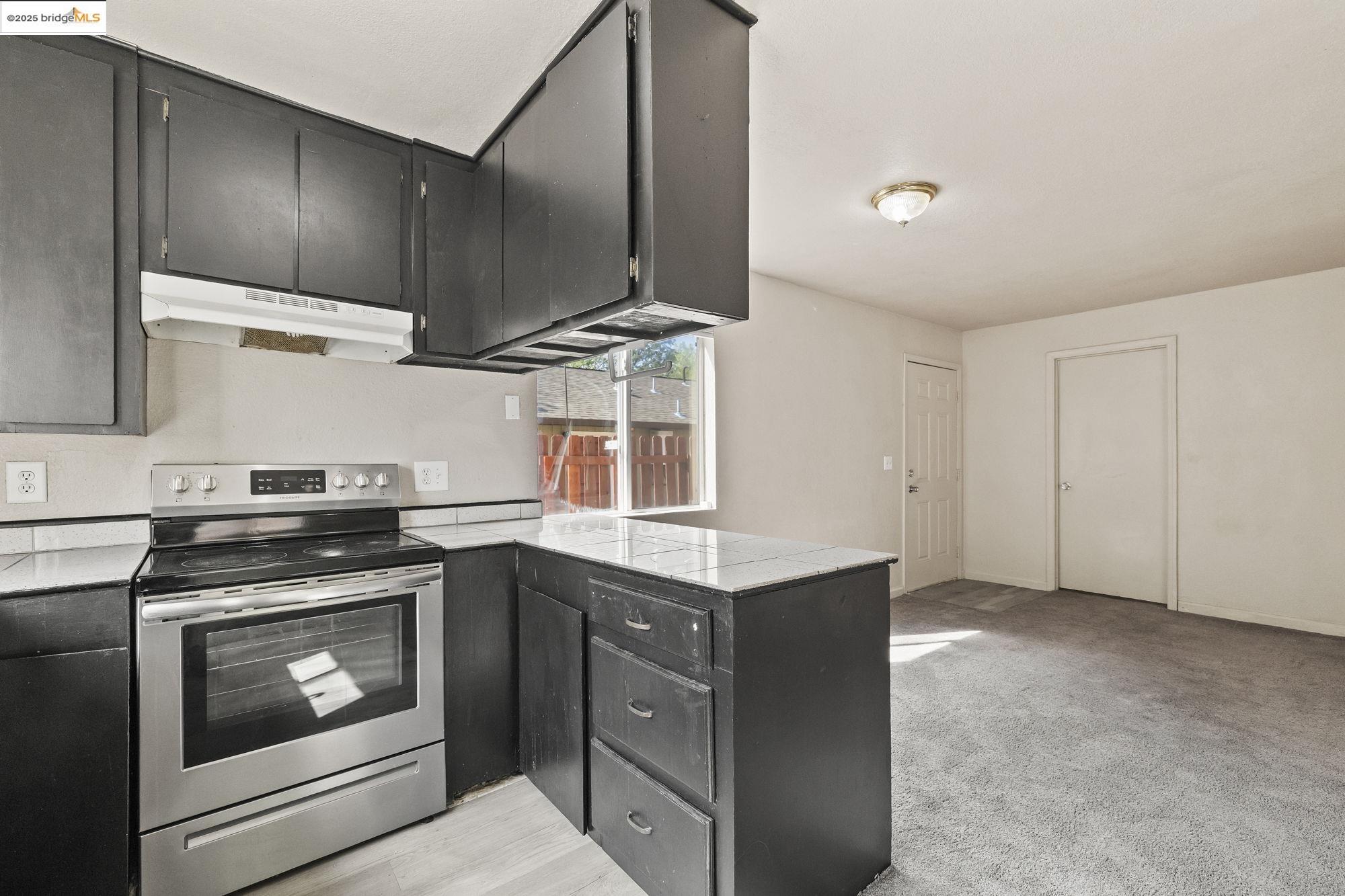 10702 10th Avenue Jamestown, CA 95327 - Photo 10 of 25 a kitchen with a stove microwave and cabinets