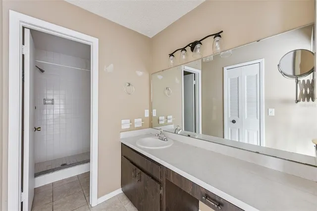a bathroom with a double vanity sink mirror and shower