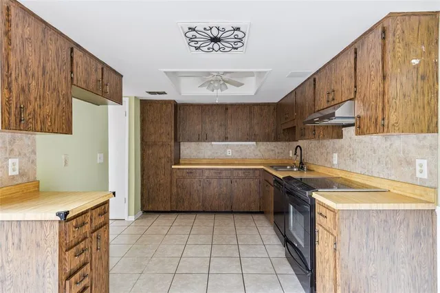 a kitchen with a sink a stove and refrigerator
