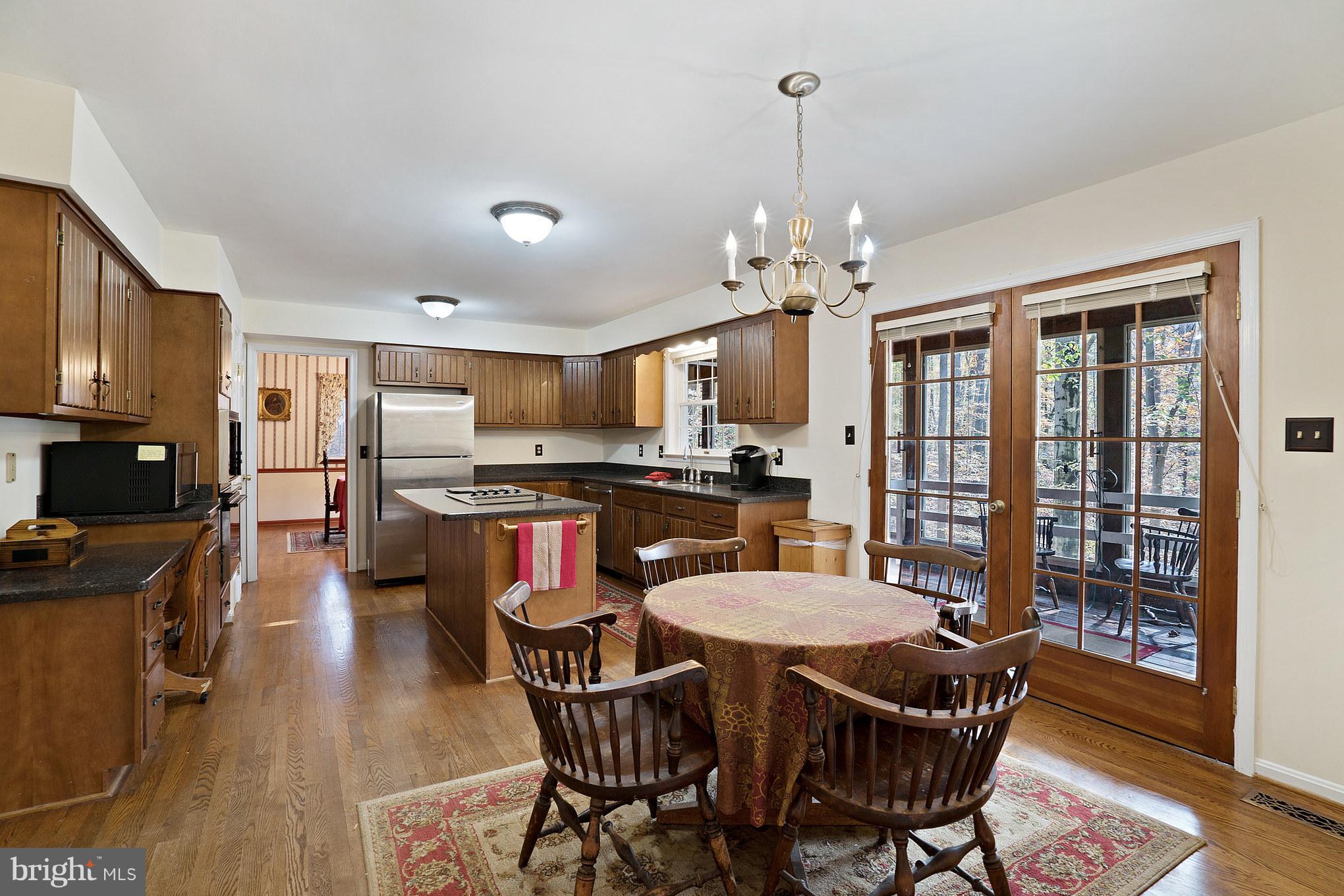 Breakfast Area in Kitchen Opens to Sunroom