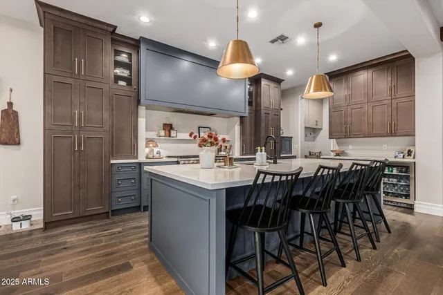 a kitchen with stainless steel appliances granite countertop a sink a stove and a refrigerator