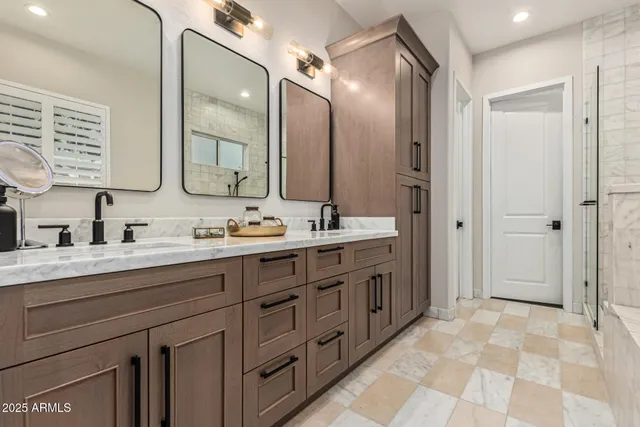 a spacious bathroom with a double vanity sink mirror and double