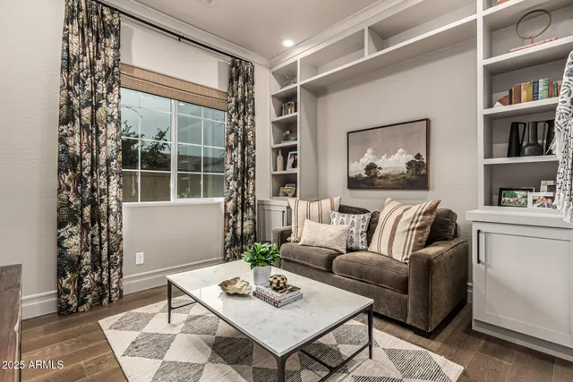a living room with furniture and a potted plant