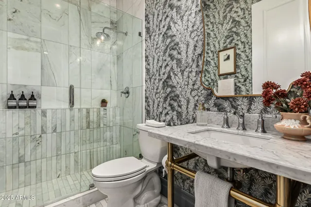 a bathroom with a sink toilet and shower