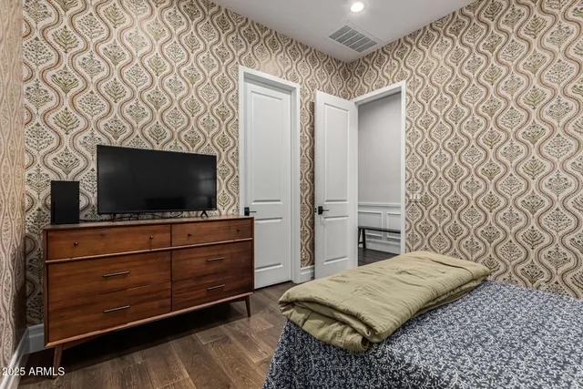 a bedroom with a bed and a flat screen tv