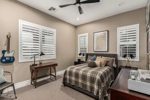 a bedroom with a bed a dresser and a window