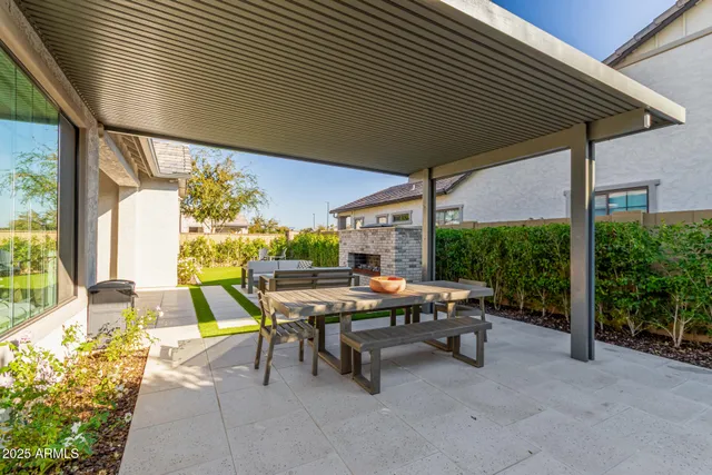 a view of a patio with table and chairs potted plants with wooden floor