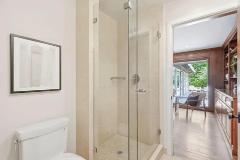 a bathroom with a toilet a sink and a mirror