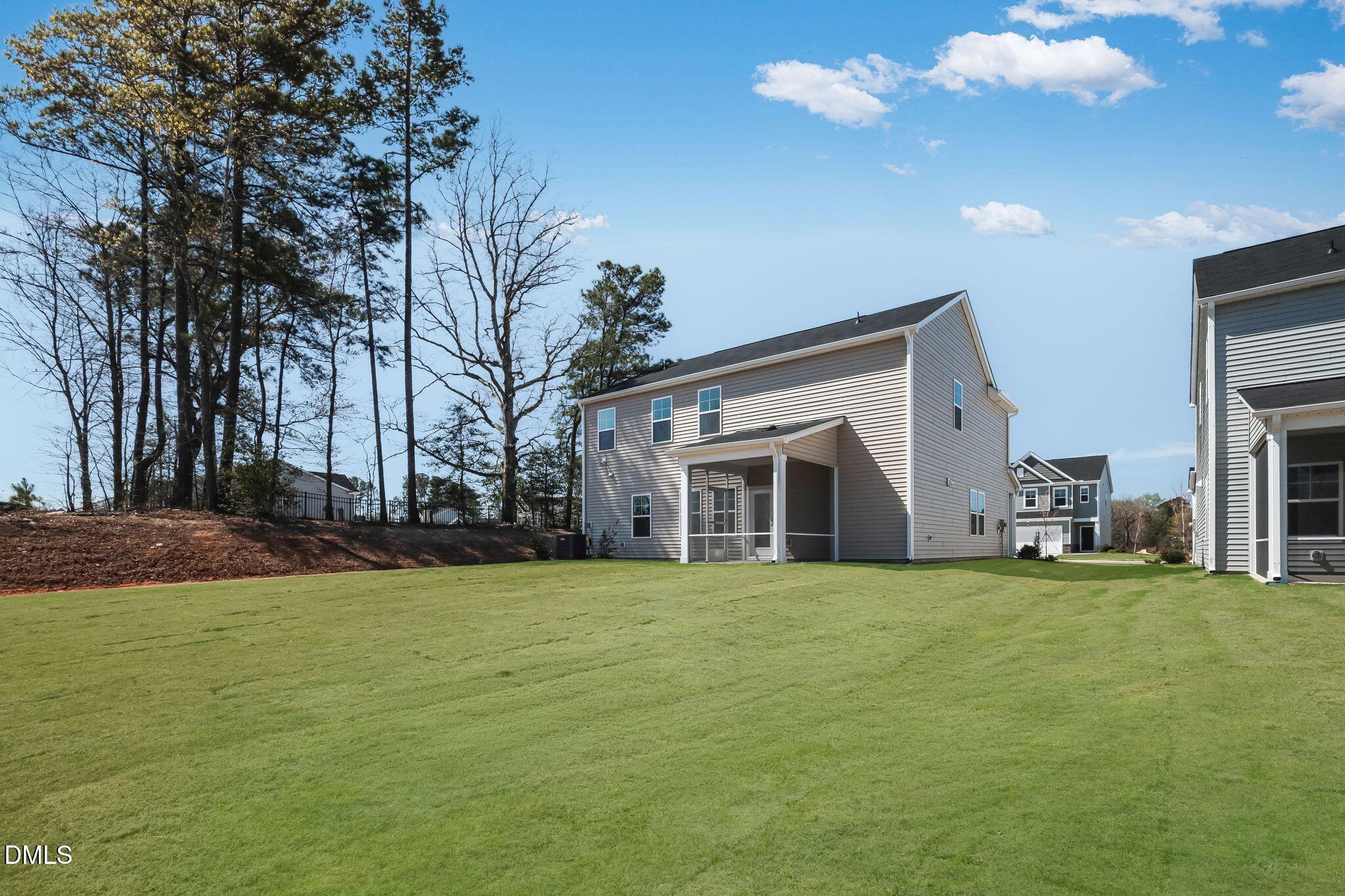 5818 Millstone Way Sims, NC 27880 - Photo 23 of 24 a view of a house with a big yard and large trees