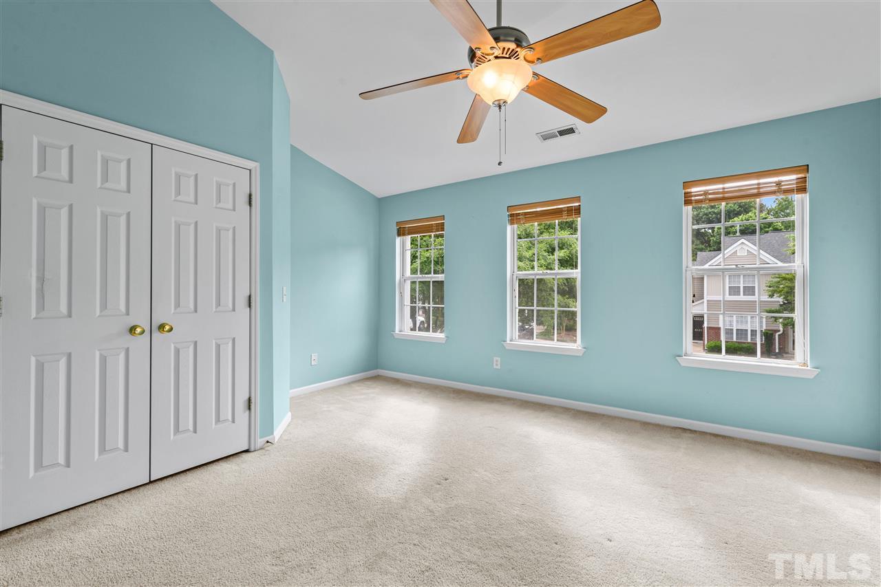 4822 Black Mountain Path Raleigh, NC 27612 - Photo 12 of 27 an empty room with chandelier fan and windows