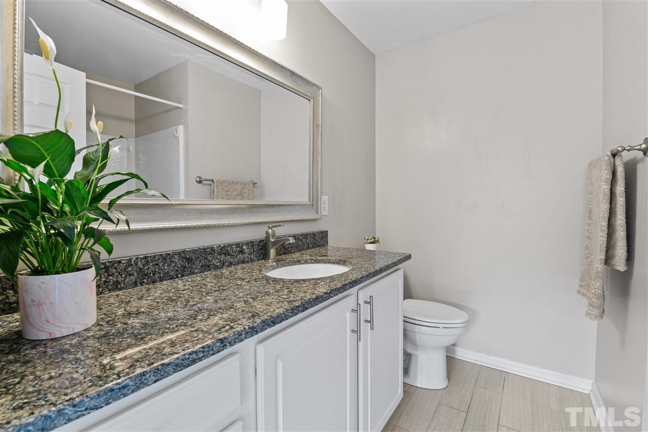 4822 Black Mountain Path Raleigh, NC 27612 - Photo 13 of 27 a bathroom with a granite countertop sink and a mirror