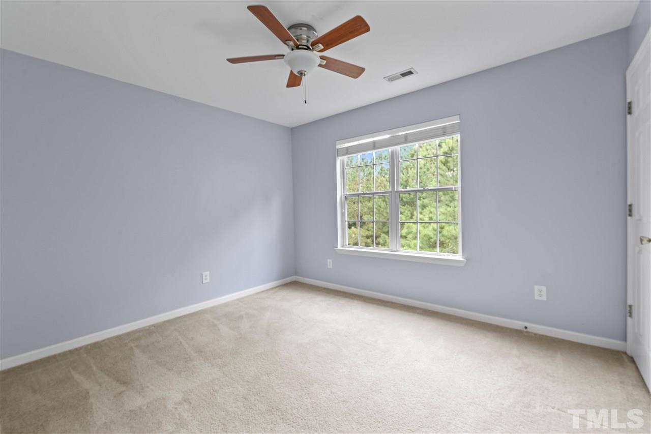 4822 Black Mountain Path Raleigh, NC 27612 - Photo 14 of 27 an empty room with a window and a fan