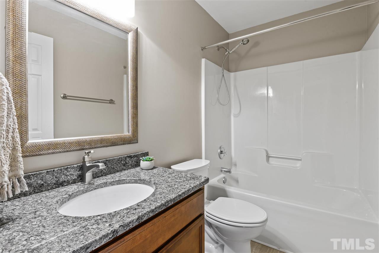 4822 Black Mountain Path Raleigh, NC 27612 - Photo 15 of 27 a bathroom with a granite countertop sink toilet a mirror and shower