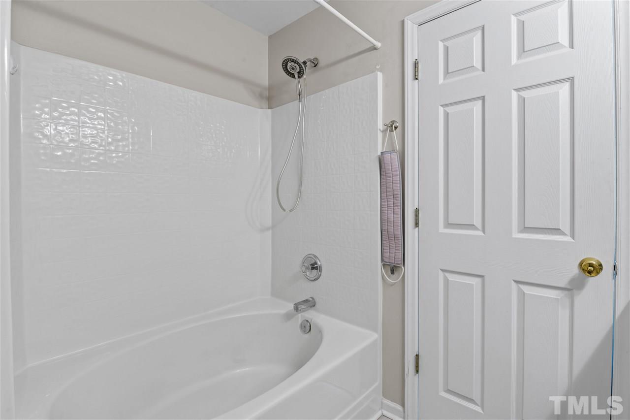 4822 Black Mountain Path Raleigh, NC 27612 - Photo 16 of 27 a white bath tub sitting next to a shower