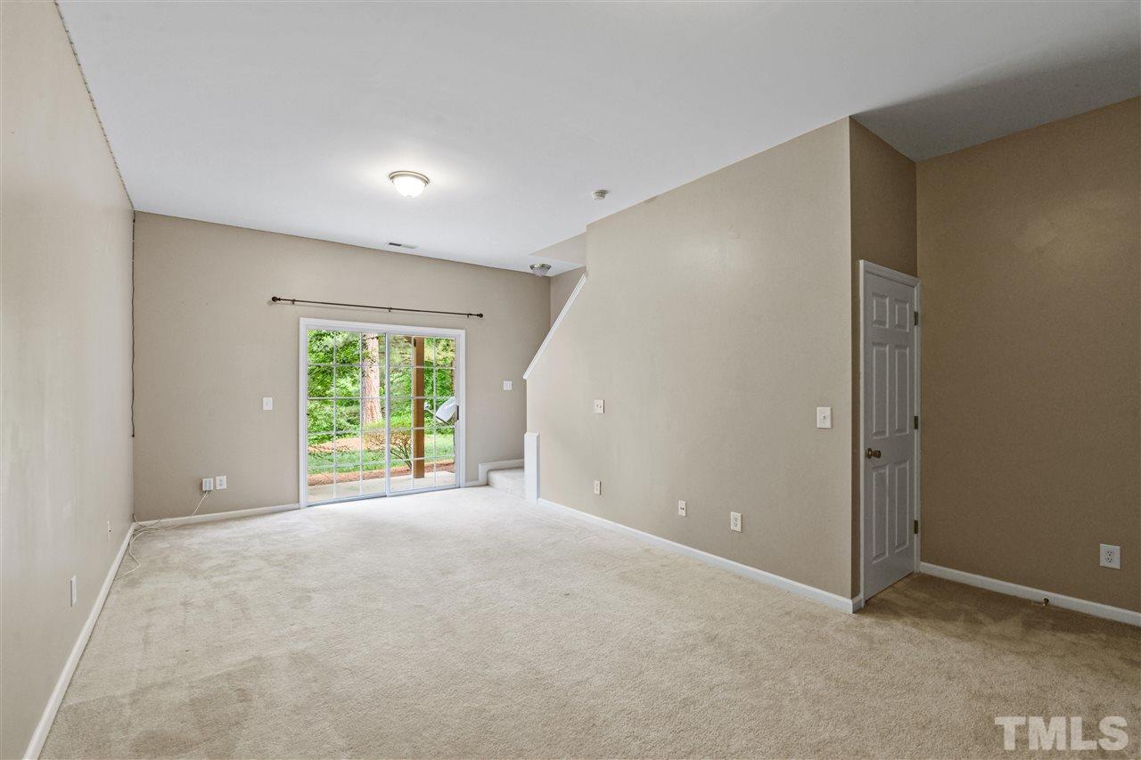 4822 Black Mountain Path Raleigh, NC 27612 - Photo 17 of 27 an empty room with windows and garden