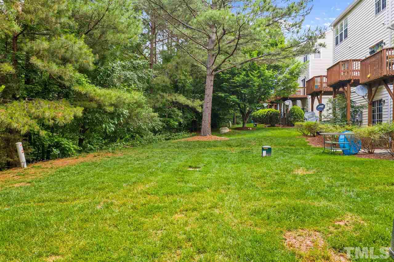 4822 Black Mountain Path Raleigh, NC 27612 - Photo 26 of 27 a backyard of a house with lots of green space and fountain