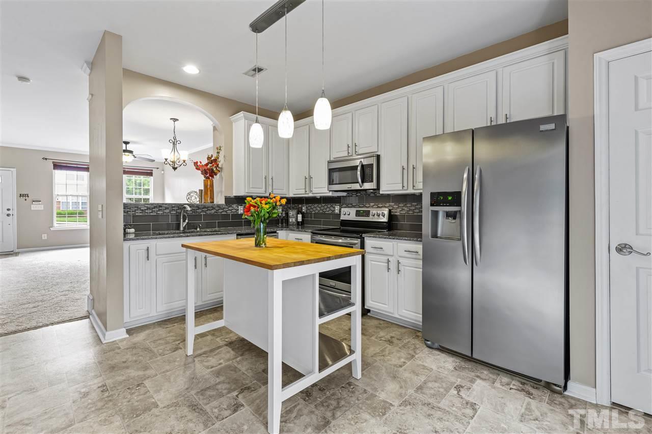 4822 Black Mountain Path Raleigh, NC 27612 - Photo 6 of 27 a kitchen with stainless steel appliances granite countertop a refrigerator a stove a sink and a refrigerator