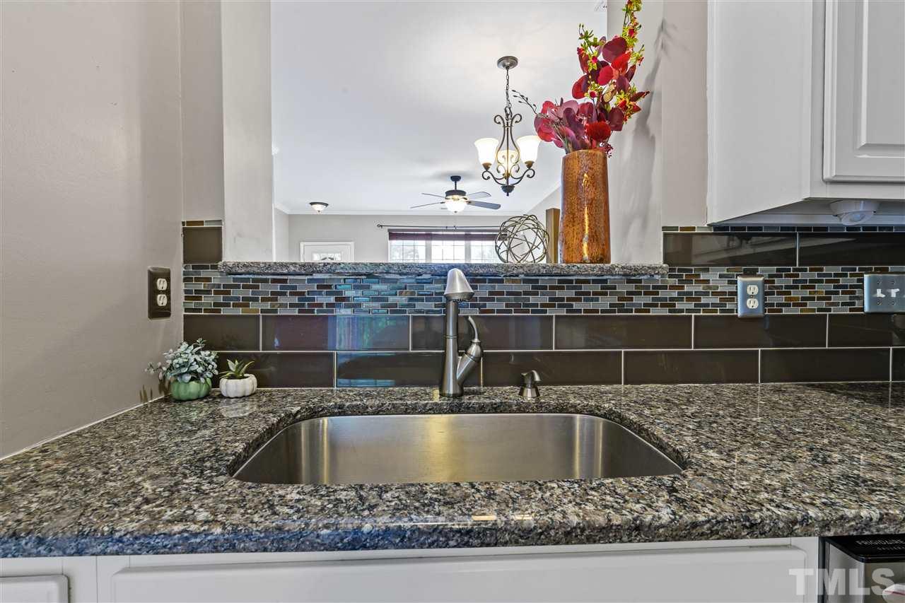 4822 Black Mountain Path Raleigh, NC 27612 - Photo 8 of 27 a kitchen with kitchen island a sink stainless steel appliances and a counter top space