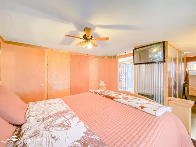 a bedroom with furniture and a large window